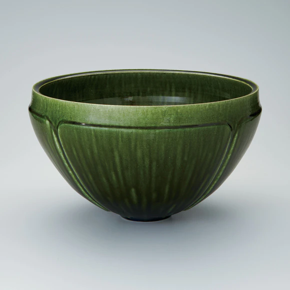 Flower vessel with green glaze.