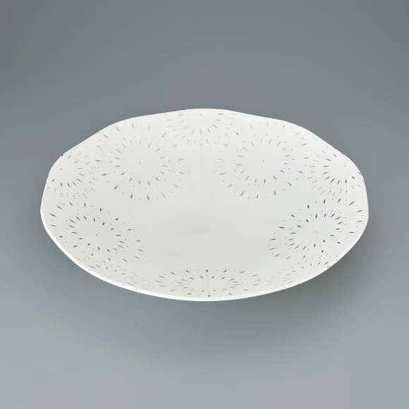 Ten sided bowl with flower design in gold.