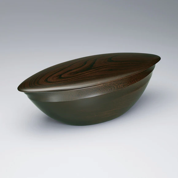 Covered bowl of zelkova wood in streamline shape finished in wiped urushi.
