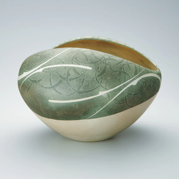 Vessel with lotus and circle design in colored slip.