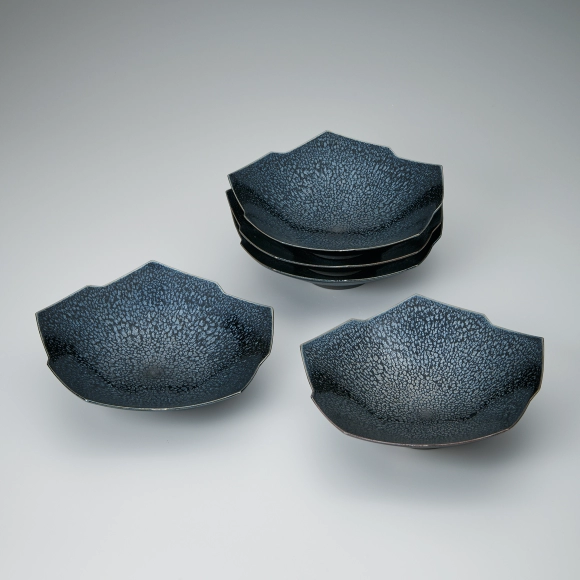 Set of bowls with iron glaze and kiln mutation effect.
