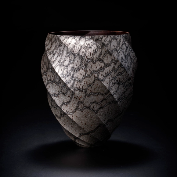 Eight sided flower vessel of mokumegane made in hammer work with twisted ridge design.