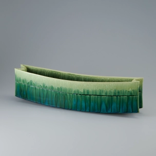 Flower vessel with green glaze.