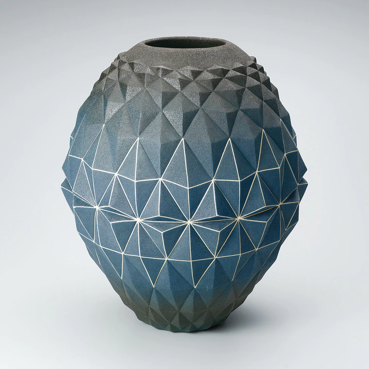 photo Gradated blue jar with geometrical design.