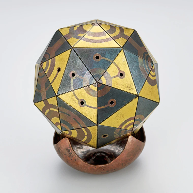 photo Rottle bell of iron and brass joined by heat welding method with design in copper cutout inlay.