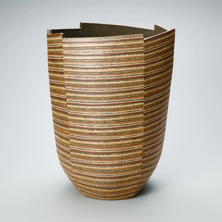 photo Flower vessel with inlay and colored slip decoration.