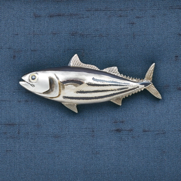 Metal fitting in shape of bonito.