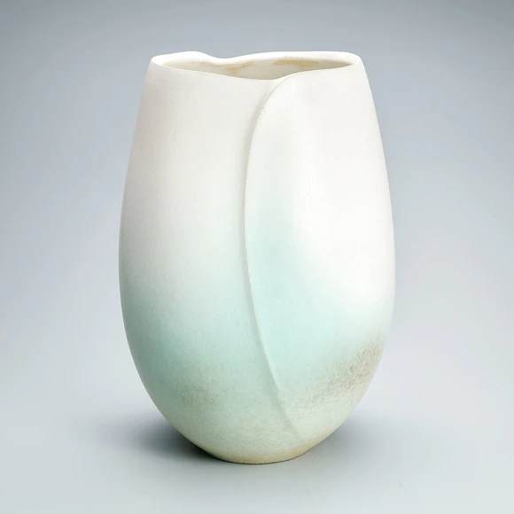 Deep bowl with greenish white glaze.