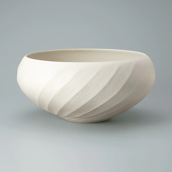 Bowl with colored slip and carved design.