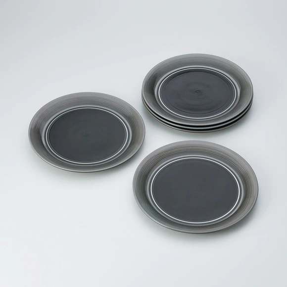 Set of dishes with dark ash glaze, engraved line and chattered pattern design.