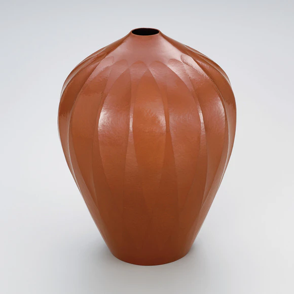 Hammer worked flower vase.