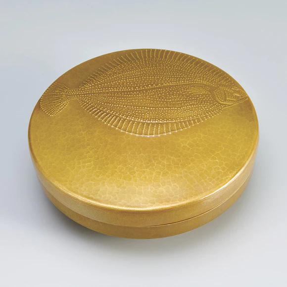 Covered box of hammer worked brass. “Moonlit night shore. Roughscale sole”