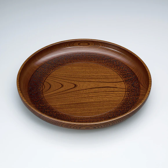 Dish of zelkova wood finished in wiped urushi.