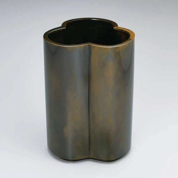 Three-leaf-shaped flower vessel cast in two different metals.