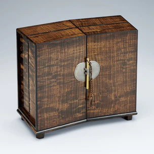 Small chest of drawers made of Japanese raisin wood finished in wiped urushi. “Uta-awase”