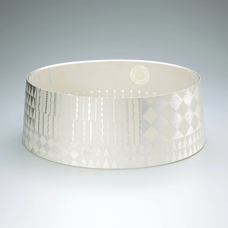 photo Bowl with light colored overglaze enamel, gold and silver.