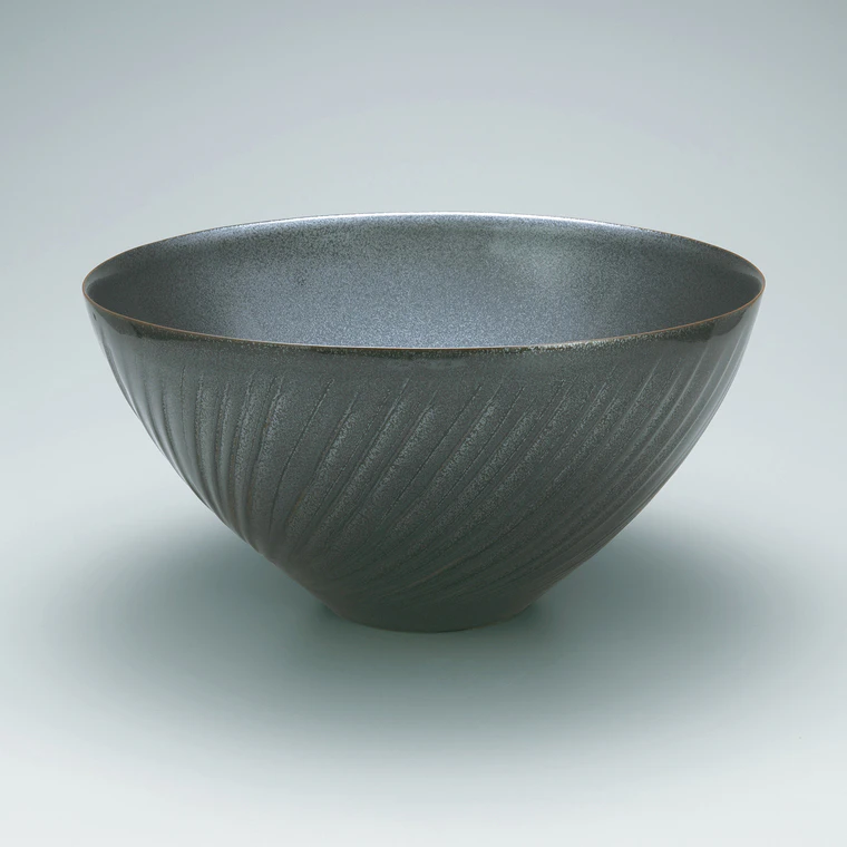 photo Bowl with tenmoku black glaze and engrave line design.