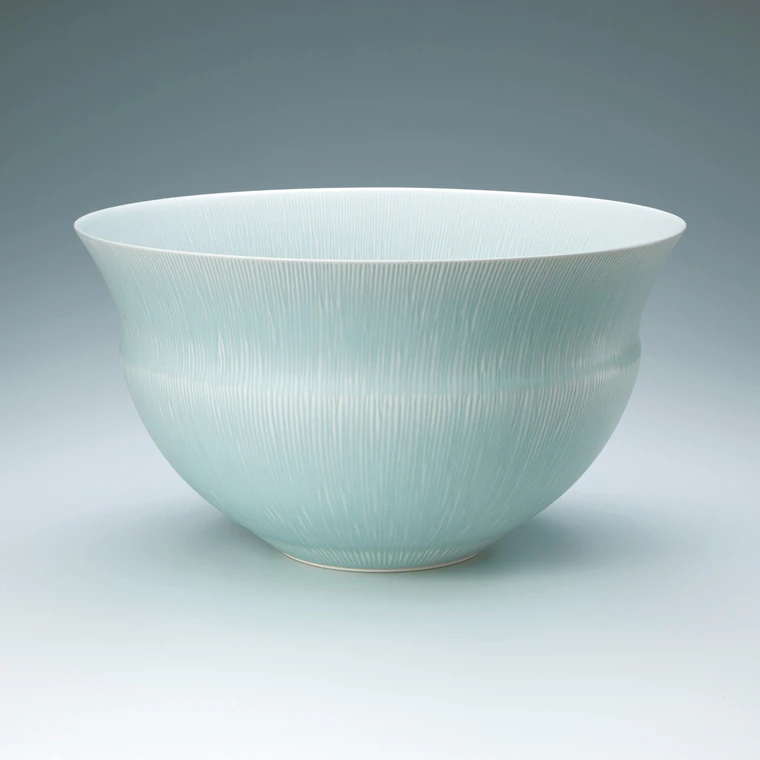 photo White porcelain bowl with icy blue glaze.