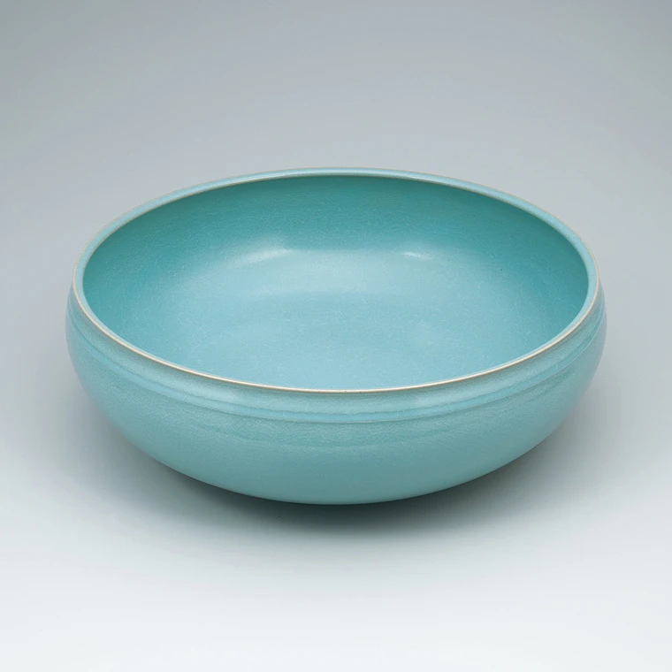 photo Bowl with celadon glaze and line design.