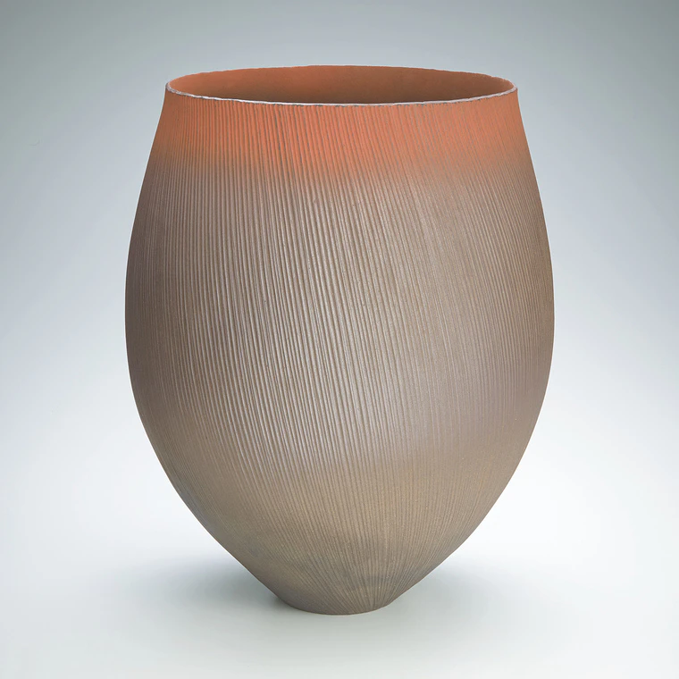 photo Red flower vessel with line design.