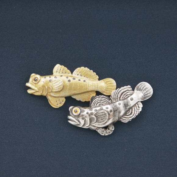 Metal fittings in shape of yellow prawn-goby.