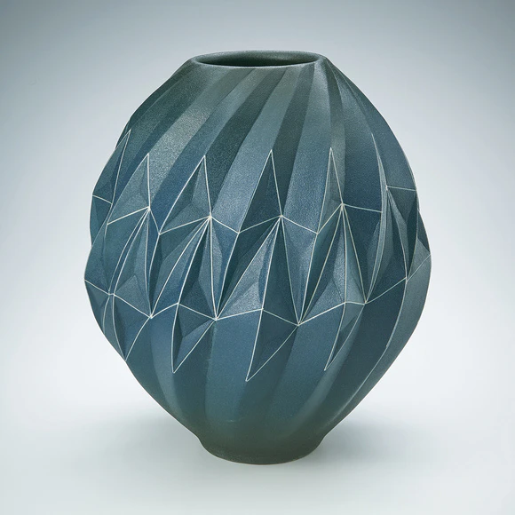 Gradated blue jar with geometrical design.