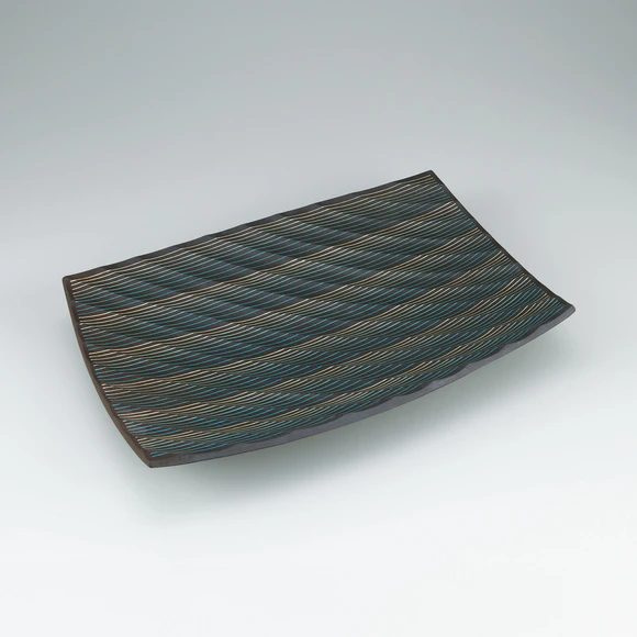 Rectangular dish with line inlay, ridge decoration and charcoal finish.