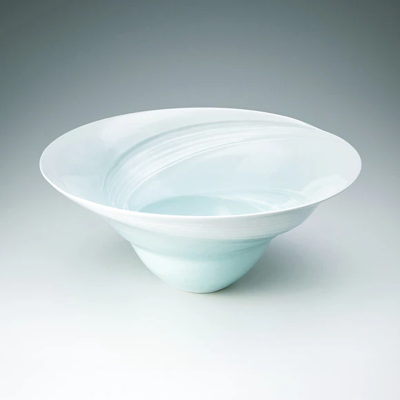White porcelain bowl with pale blue glaze and tidal current design.