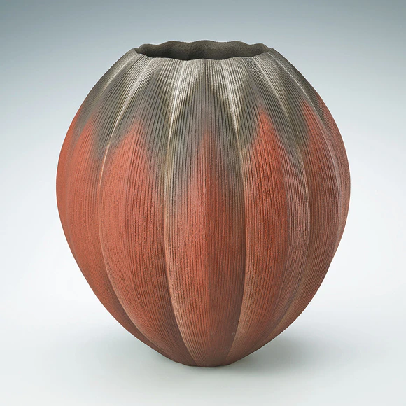 Vessel with engraved lines and colored slip painting.
