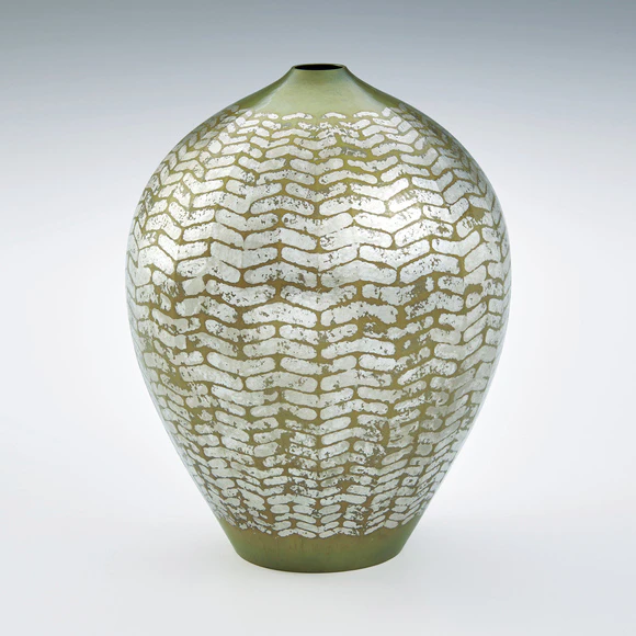 Flower vessel of forged brass with silver decoration.