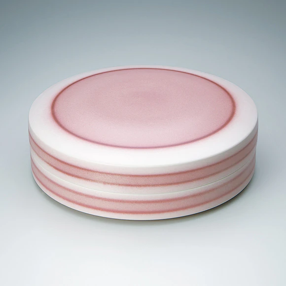 Circular box with red glaze decoration.