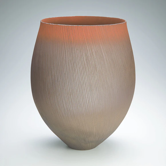 Red flower vessel with line design.