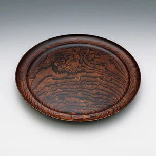 Dish of zelkova wood finished in wiped urushi.
