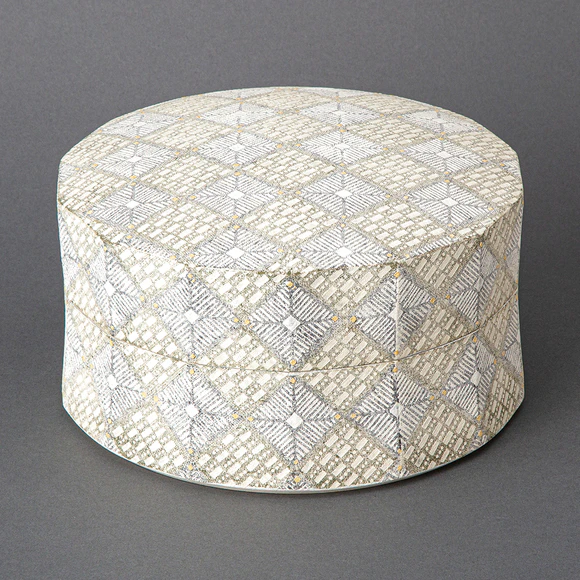 Circular box with connected minute patterns in cut paper stencil