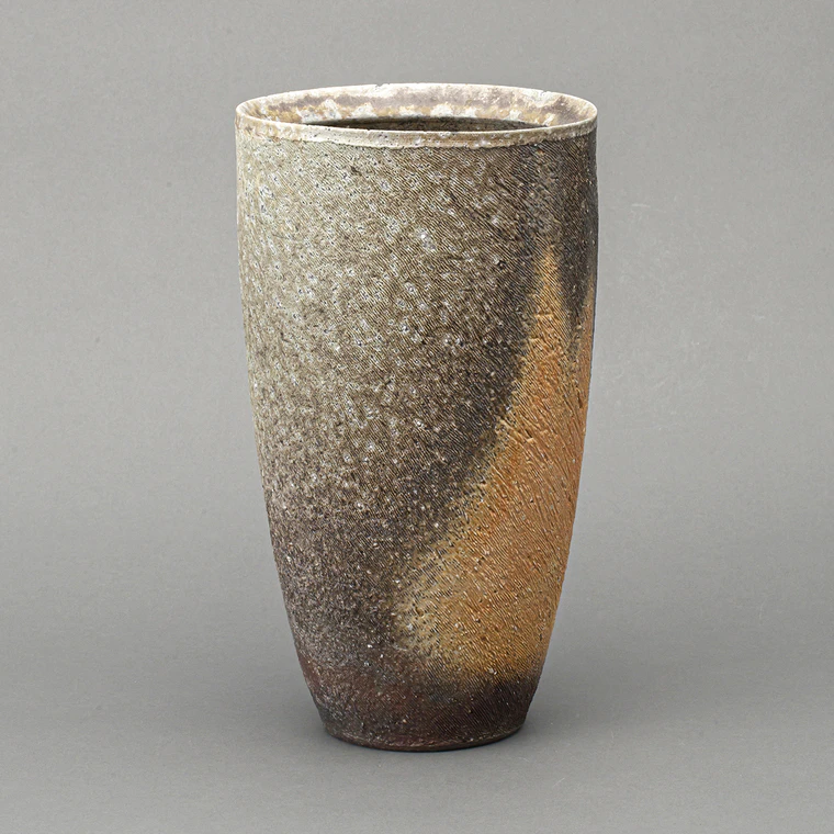 photo Cylindrical flower vessel with kiln mutation effects.