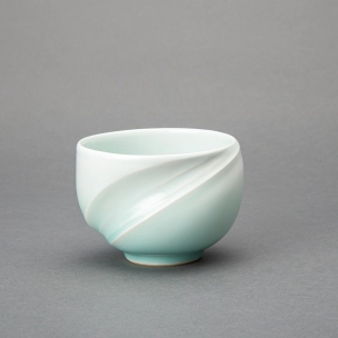 White porcelain tea bowl with pale blue glaze and tidal current design