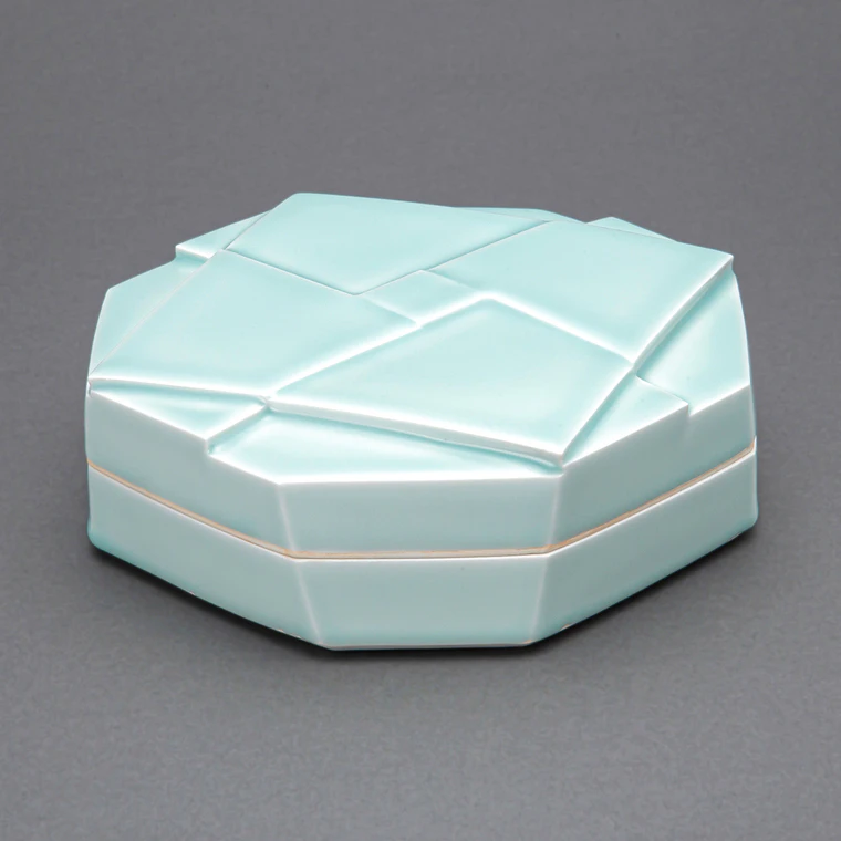 photo White Porcelain Covered Vessel with Pale Blue Glaze and Geometrical Design