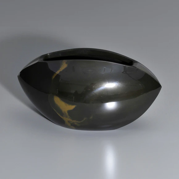 Flower vessel cast in two different metals.