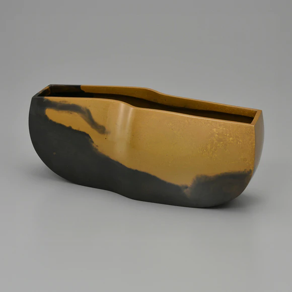 Flower vessel cast in two different metals.