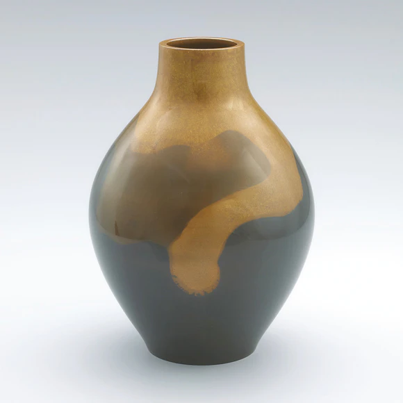 Flower vessel cast in two different metals.
