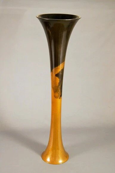 Flower vessel cast in two different metals.