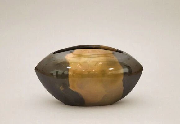 Flower vessel cast in two different metals.