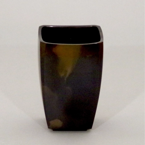 Flower vessel cast in two different metals.