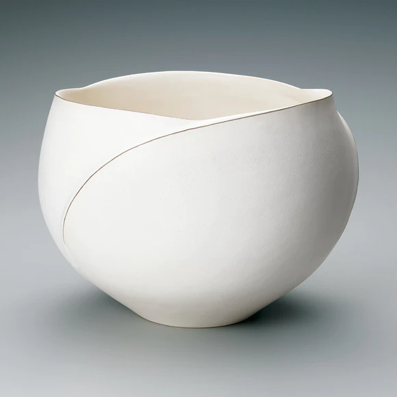 Bowl with white glaze and ridged line design.