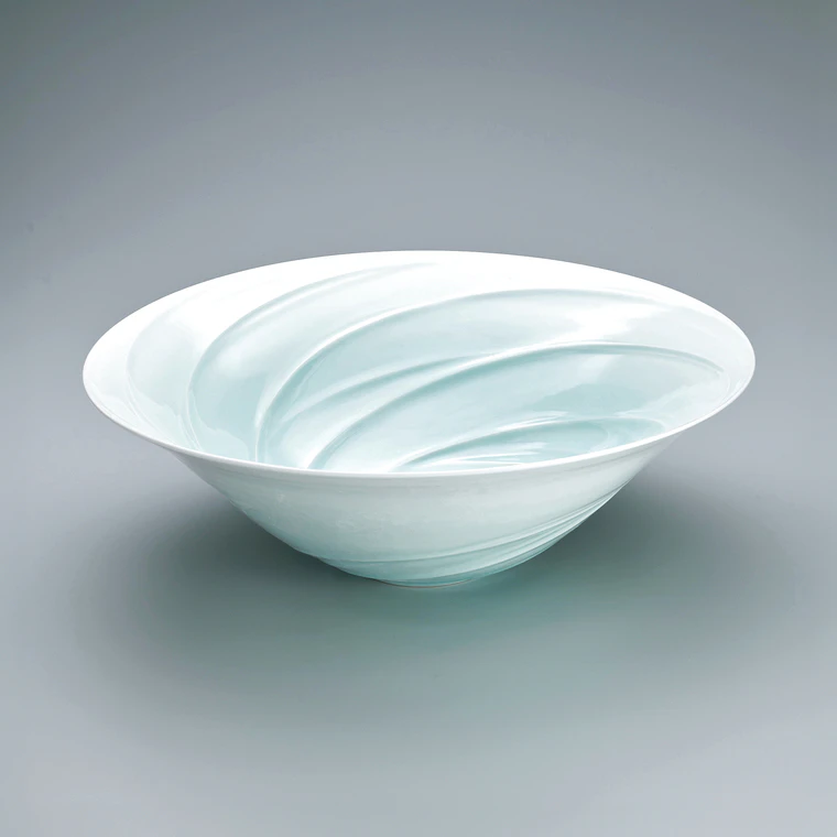 photo White porcelain bowl with pale blue glaze and stream design