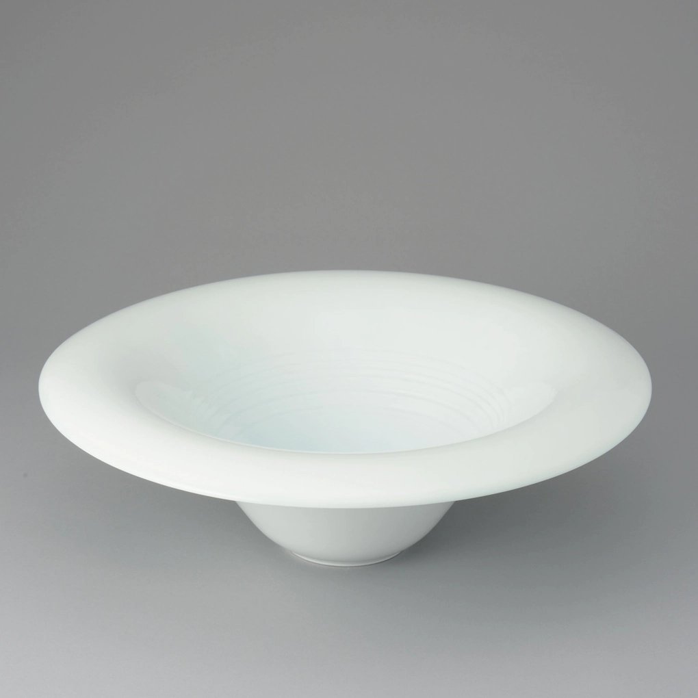 photo White Porcelain Bowl with Pale Blue Glaze "Wave Pattern"