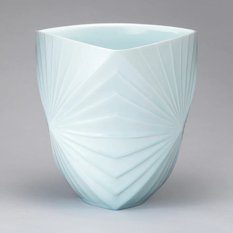 photo White Porcelain Vessel with Pale Blue Glaze and Engraved Line Design