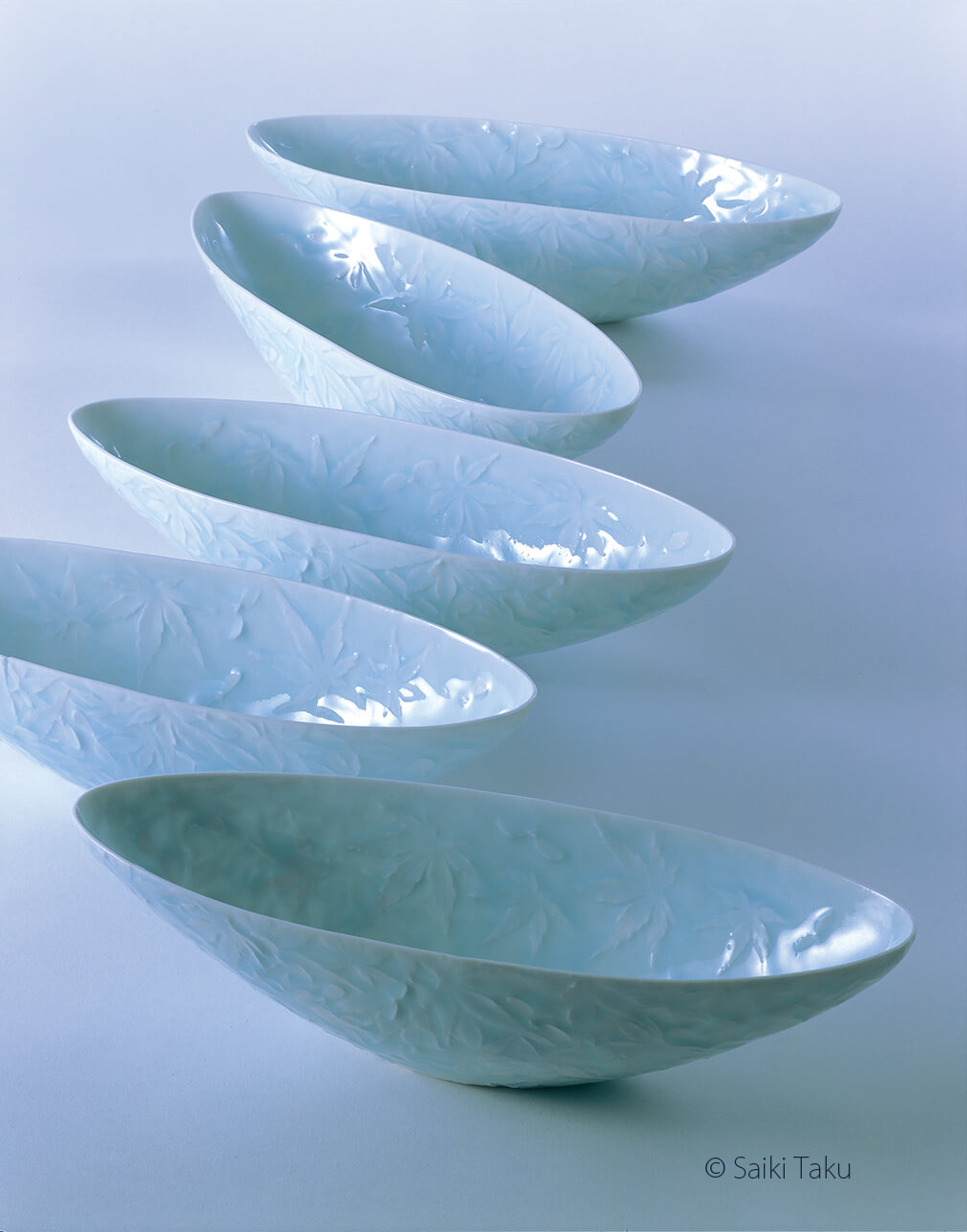 photo Set of white porcelain dishes with pale blue glaze and maple design
