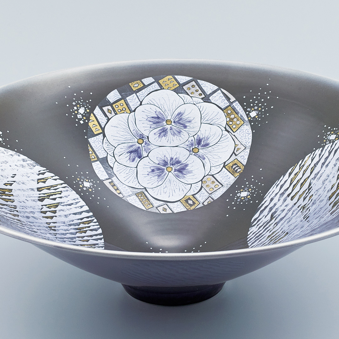 photo Bowl with flower design in silver and gold under aster glaze on purple ground